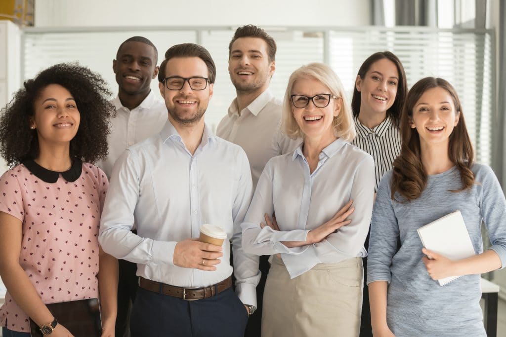 Smiling multiethnic employees standing looking at camera