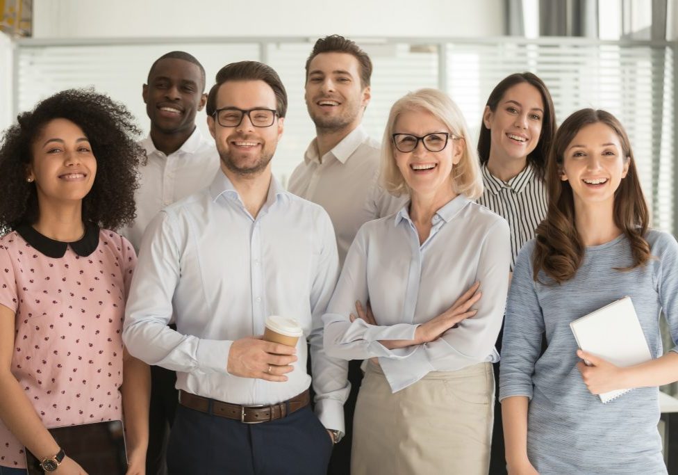 Smiling multiethnic employees standing looking at camera